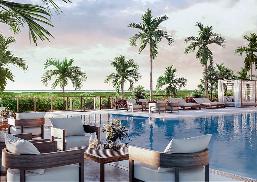 Pool Amenities Resort style pool deck at Island West Bay with lounge seating and views of Estero Bay and coastal mangroves
