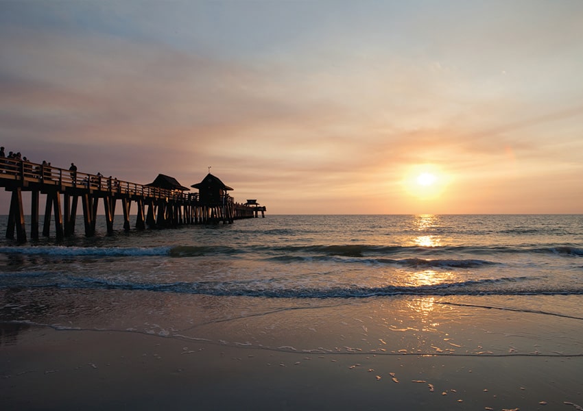 The Naples Pier sun setting over the naples pier