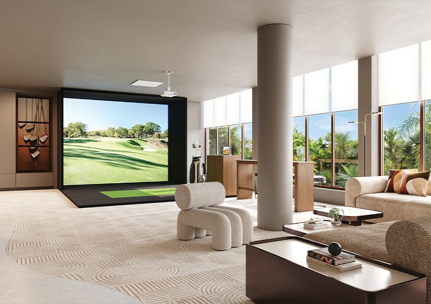 Sports Lounge Sports lounge at Island West Bay featuring a golf simulator and modern seating with views of tropical greenery